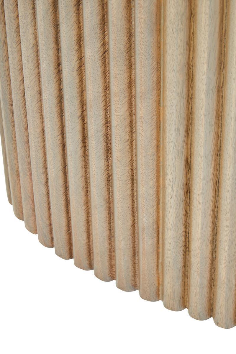 Closeup of fluted wood table base with natural grain finish