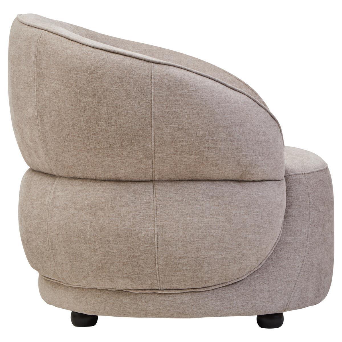 Beige fabric accent chair with rounded backrest and black feet, side view