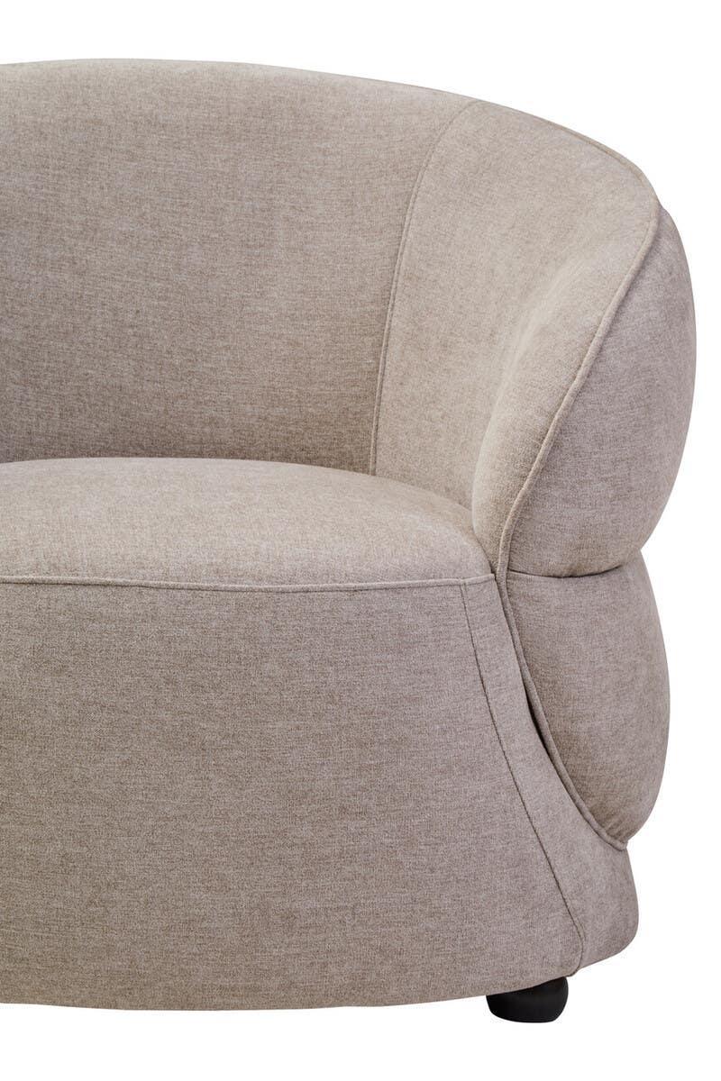 Curved beige fabric armchair with plush upholstery, close-up of seat and backrest