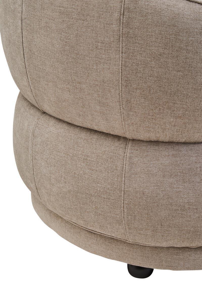 Closeup of beige fabric sofa base with visible stitching and rounded cushion design