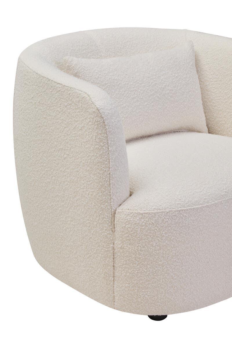 Cream boucle armchair with curved backrest and matching cushion, close-up view