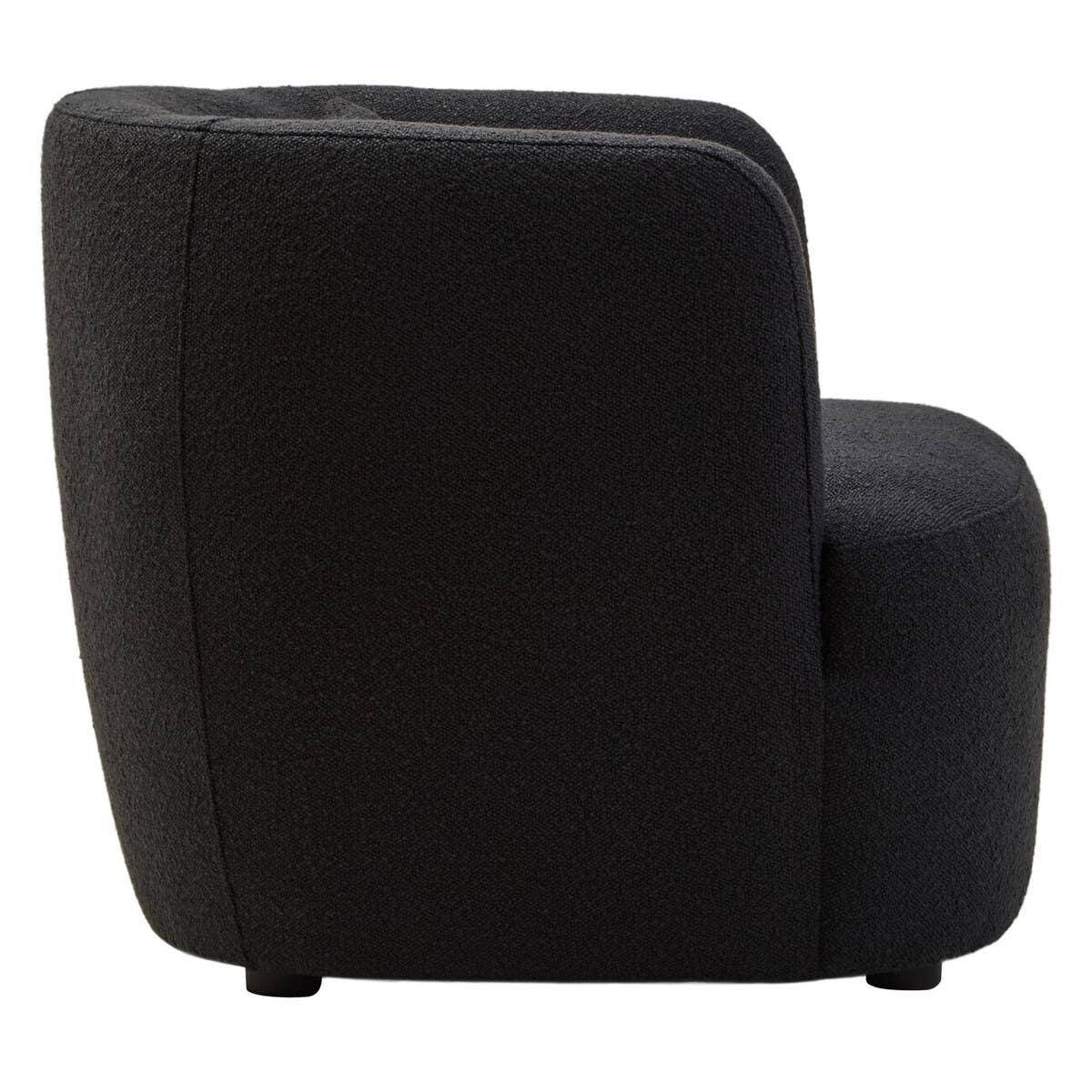 Side view of black fabric accent chair with rounded back and modern design
