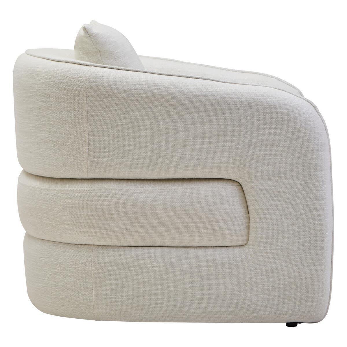 Side view of cream fabric sofa chair with plush cushion and curved armrest