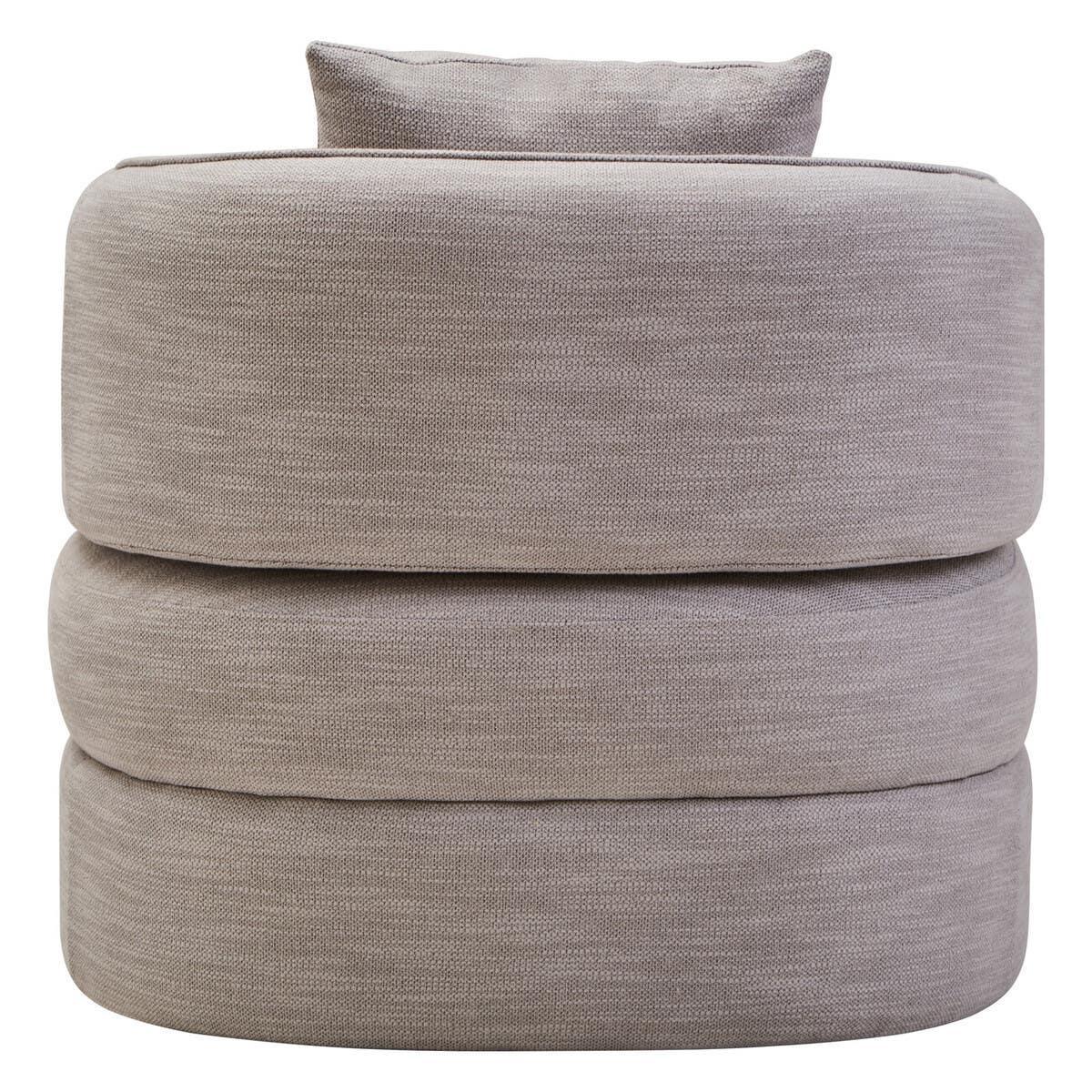 Round beige fabric ottoman with stacked cushions and matching pillow, front view