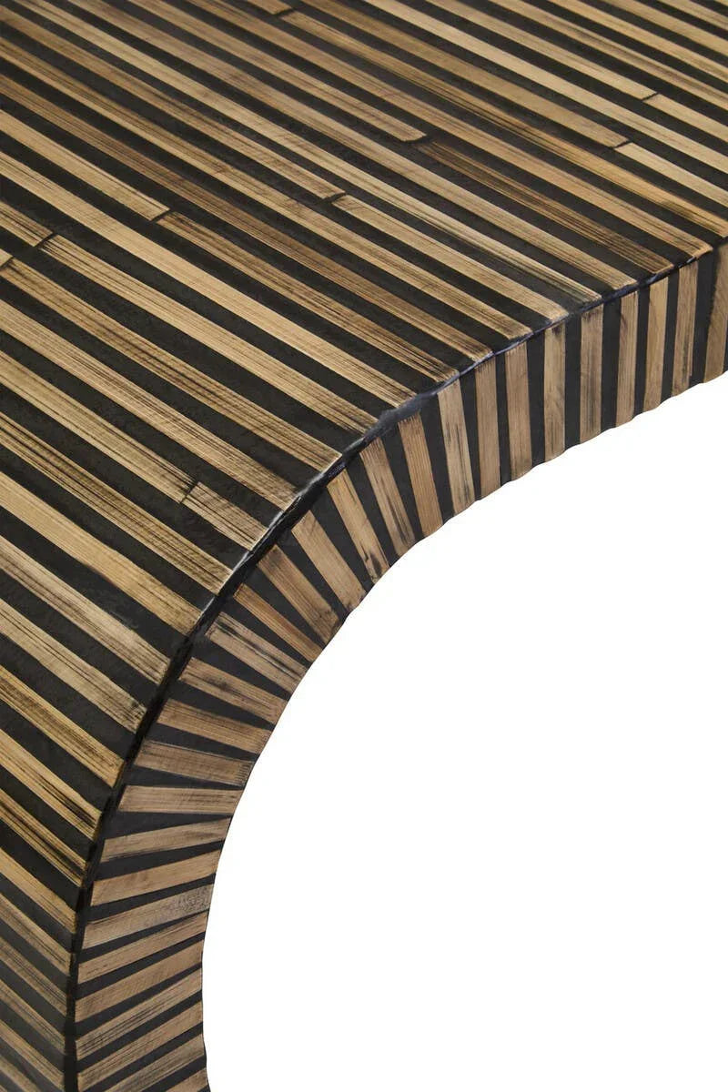 Close-up of striped wood coffee table corner with rounded edge and natural finish