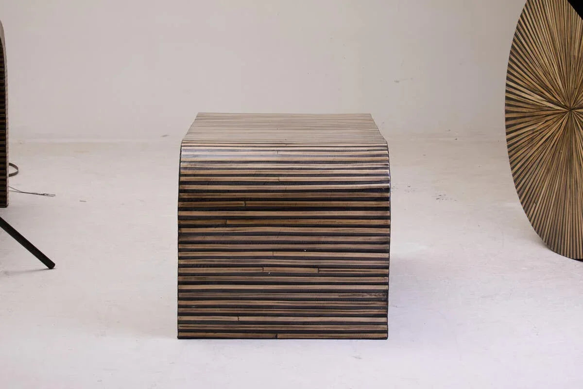 Striped wooden coffee table with curved sides on light floor