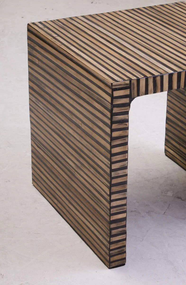 Striped wood side table with black and natural finish, close-up on square leg design