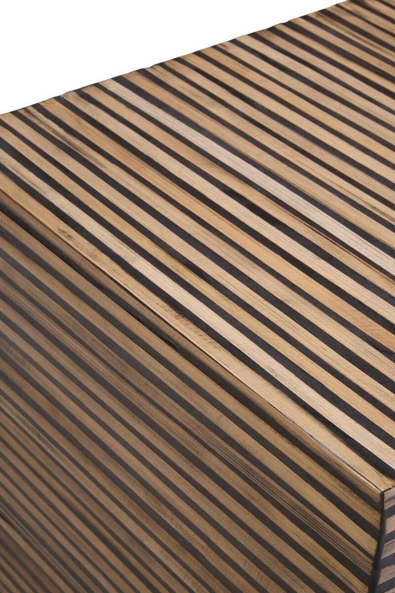 Closeup of wood chest with black and natural vertical striped pattern