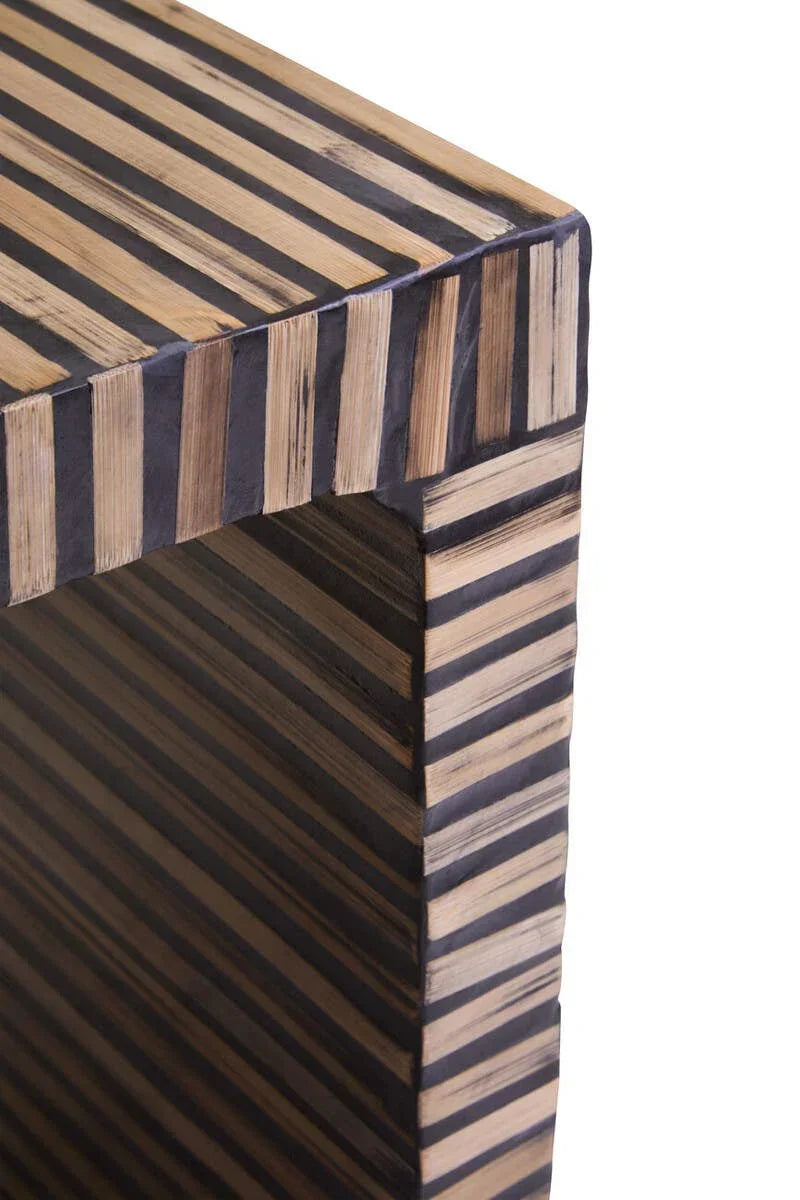 Striped wood and black accent side table corner with modern geometric design