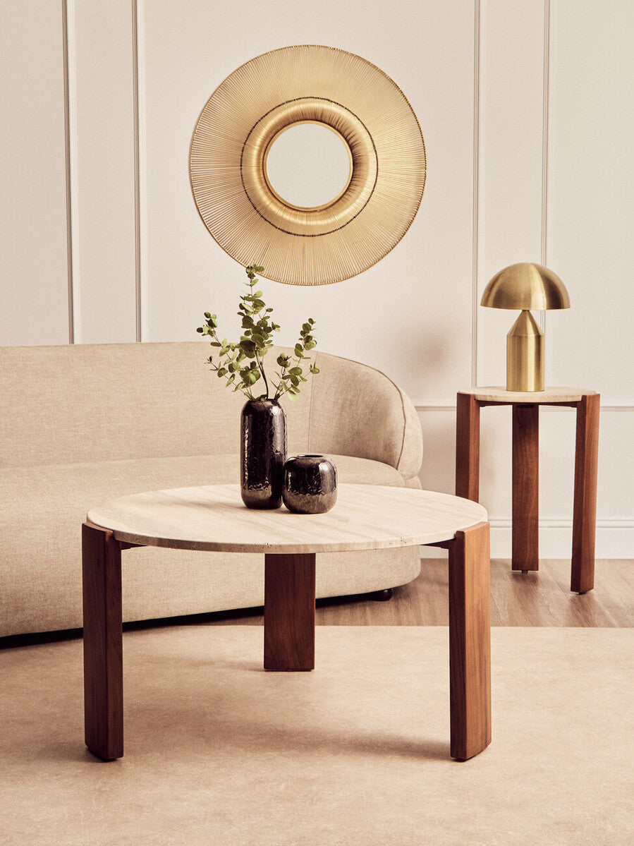 Round coffee table featuring a natural travertine marble top supported by sturdy acacia wood legs.