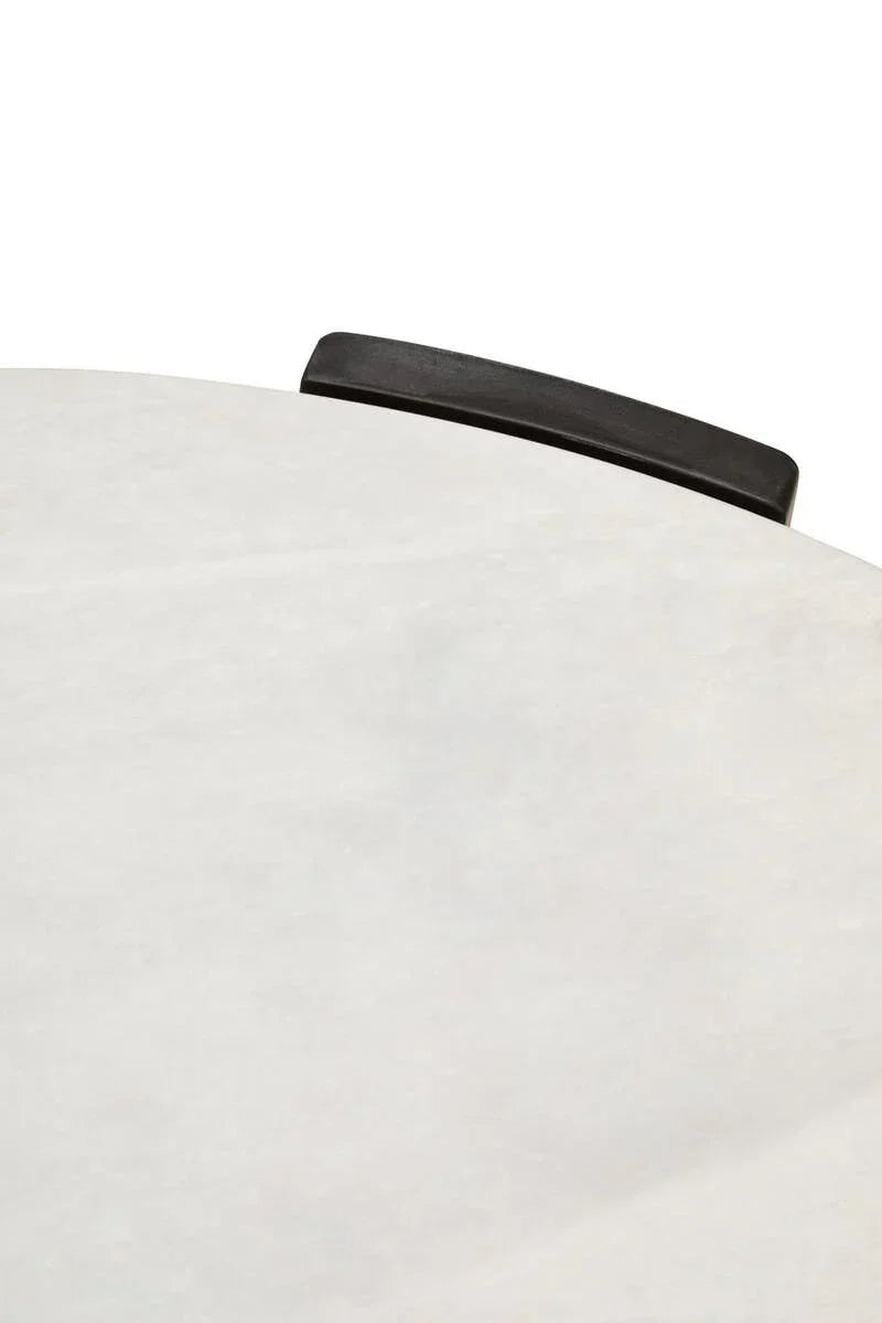Closeup of round marble table top with black edge detail
