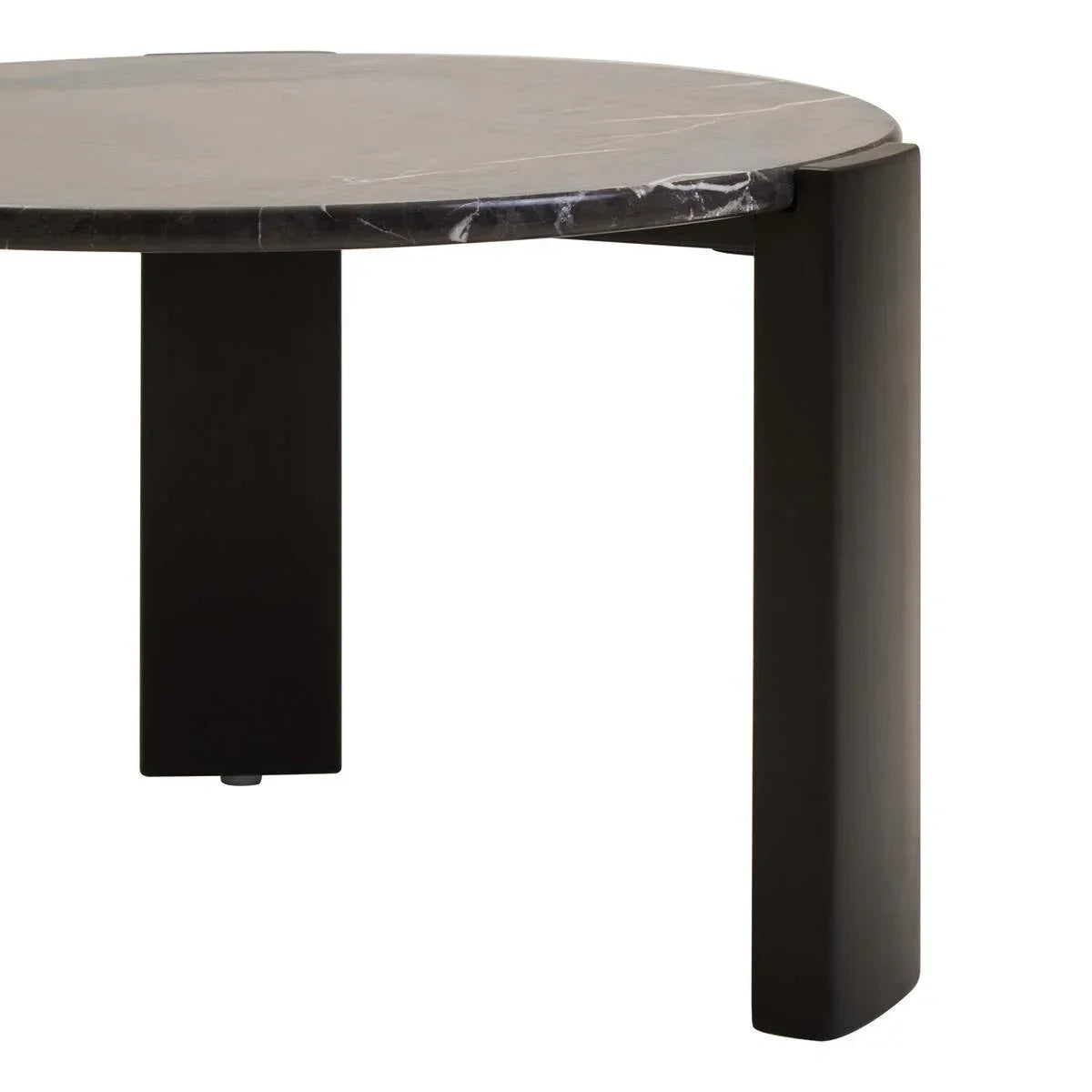 Round black marble coffee table with wide black legs, close-up view of tabletop and legs