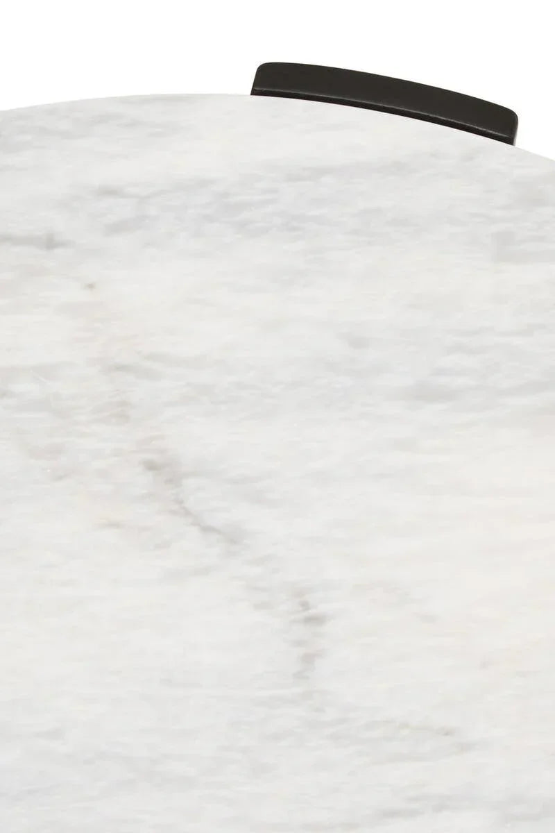 White marble tabletop with subtle veining and black edge detail, close-up view