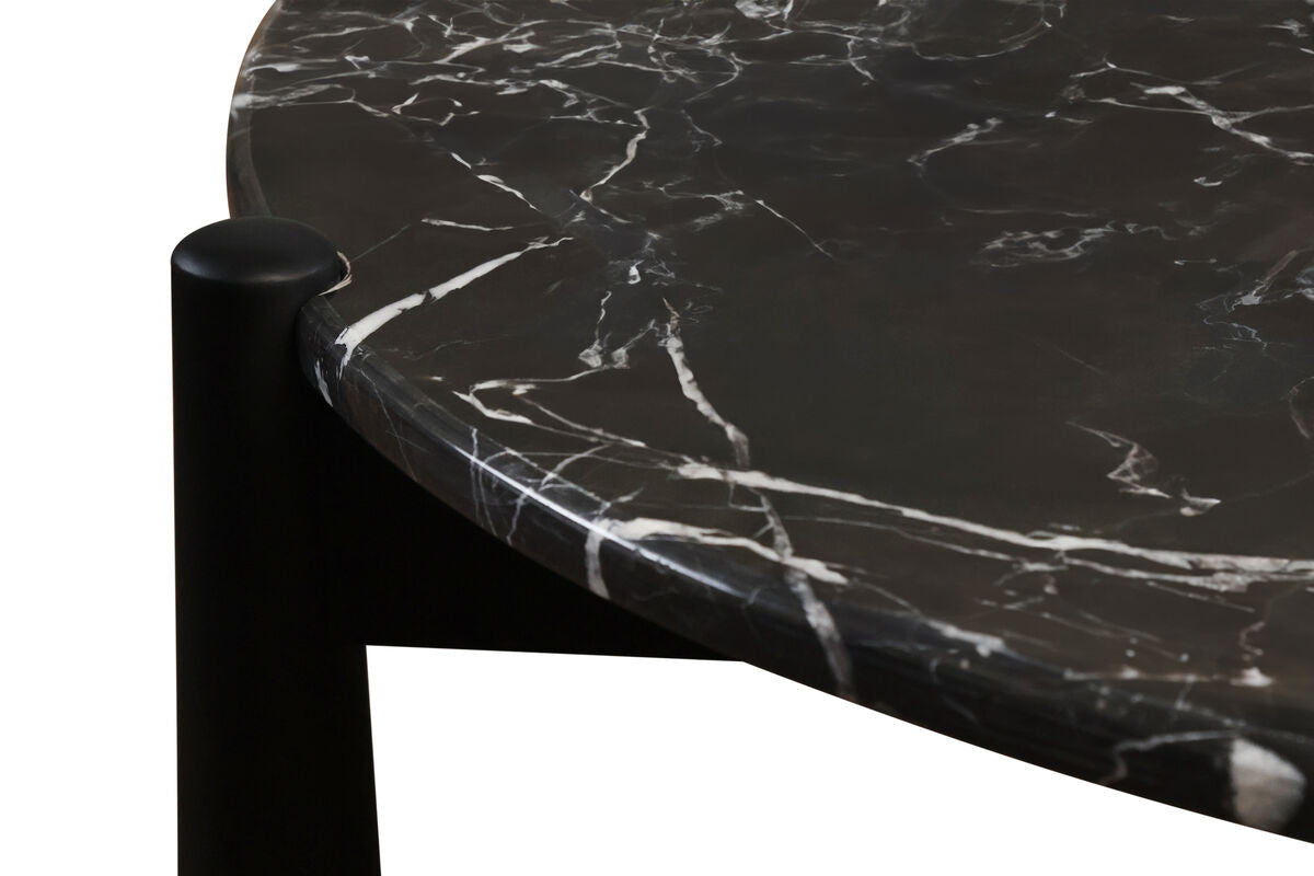 Black and white marble top coffee table featuring a smooth, rounded edge with striking white veining against a dark background, supported by sturdy black mango wood legs.