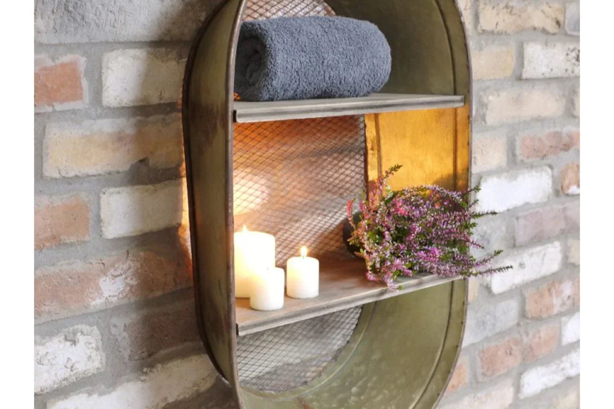 Industrial metal wall shelf with rolled towel, candles, and potted plant on brick wall