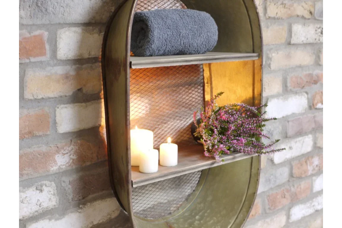 Industrial wall shelf with grey towel, candles, and purple flowers against brick wall