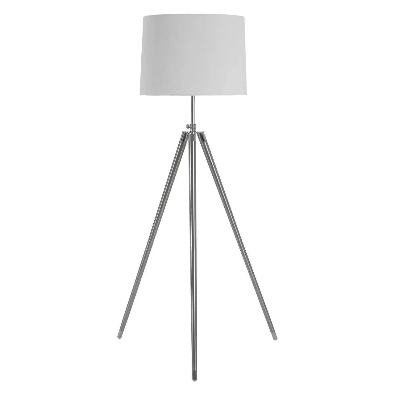 Tripod floor lamp with white drum shade and chrome legs on white background