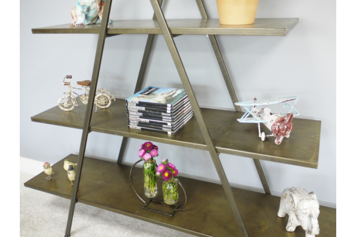 Triangular metal display shelves in bronze finish, shown angled with decorative items on three levels
