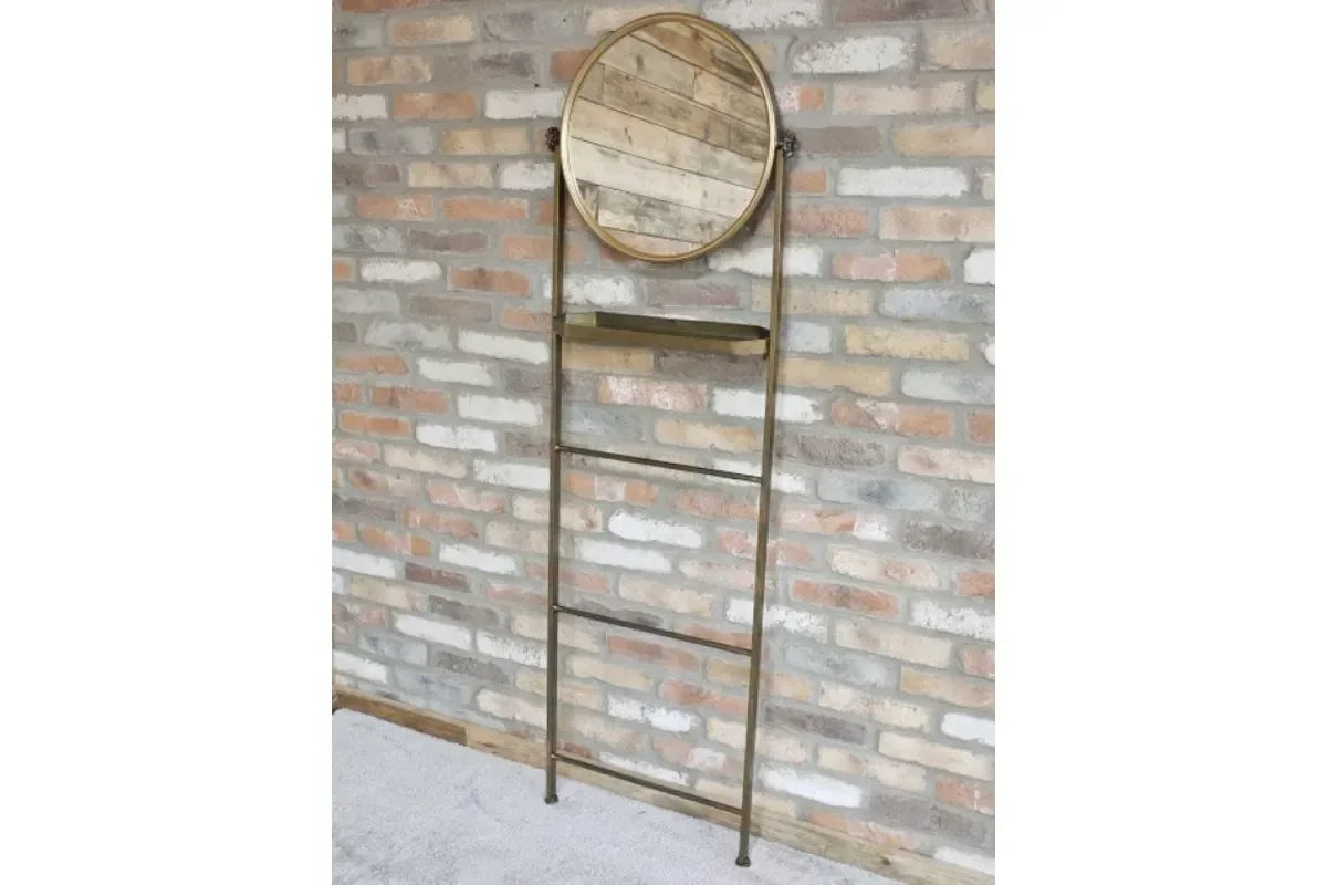 Wood and metal ladder shelf with round mirror against exposed brick wall