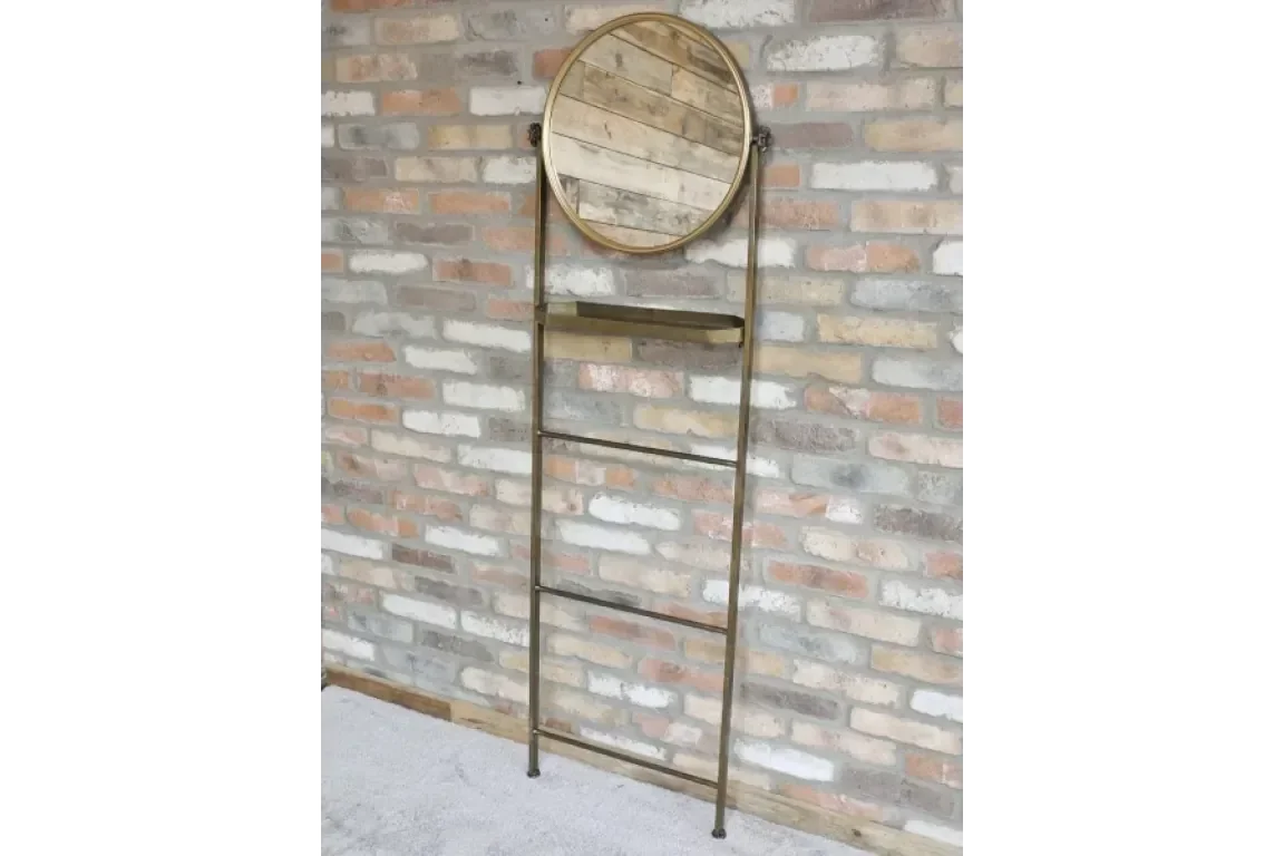 Industrial ladder mirror with wooden shelf and metal frame against brick wall
