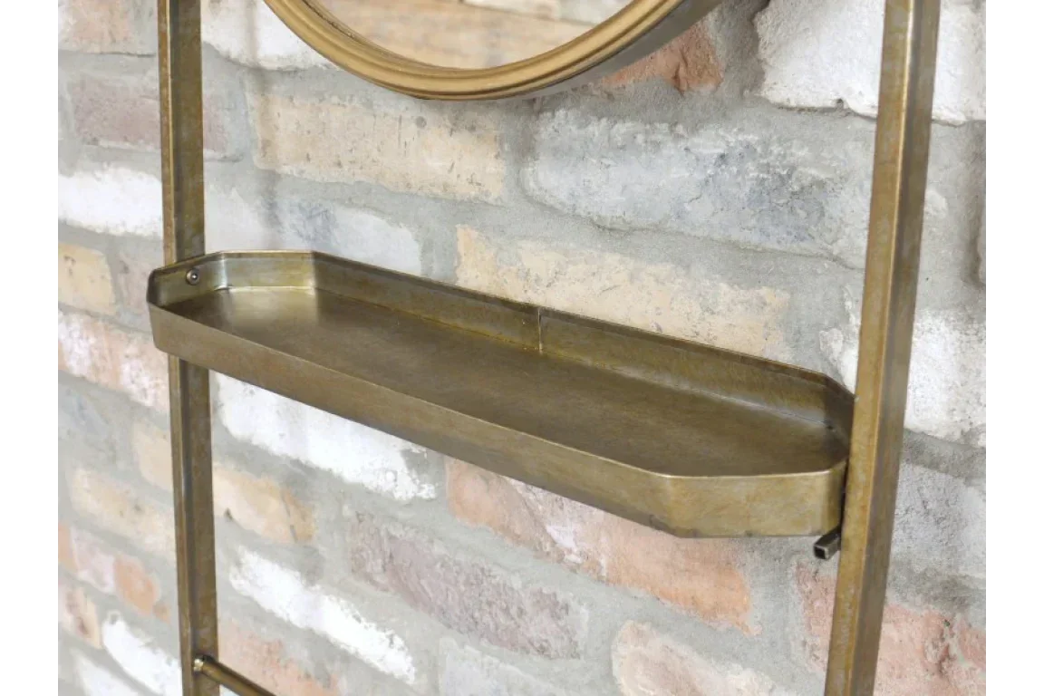 Metal wall shelf with antique brass finish mounted on exposed brick wall