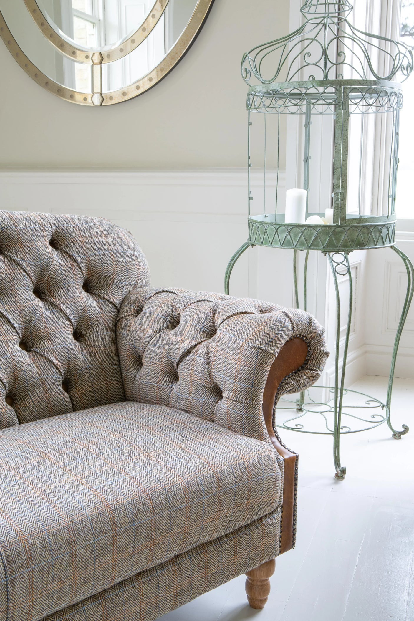 Herringbone fabric armchair with tufted backrest in bright living room setting
