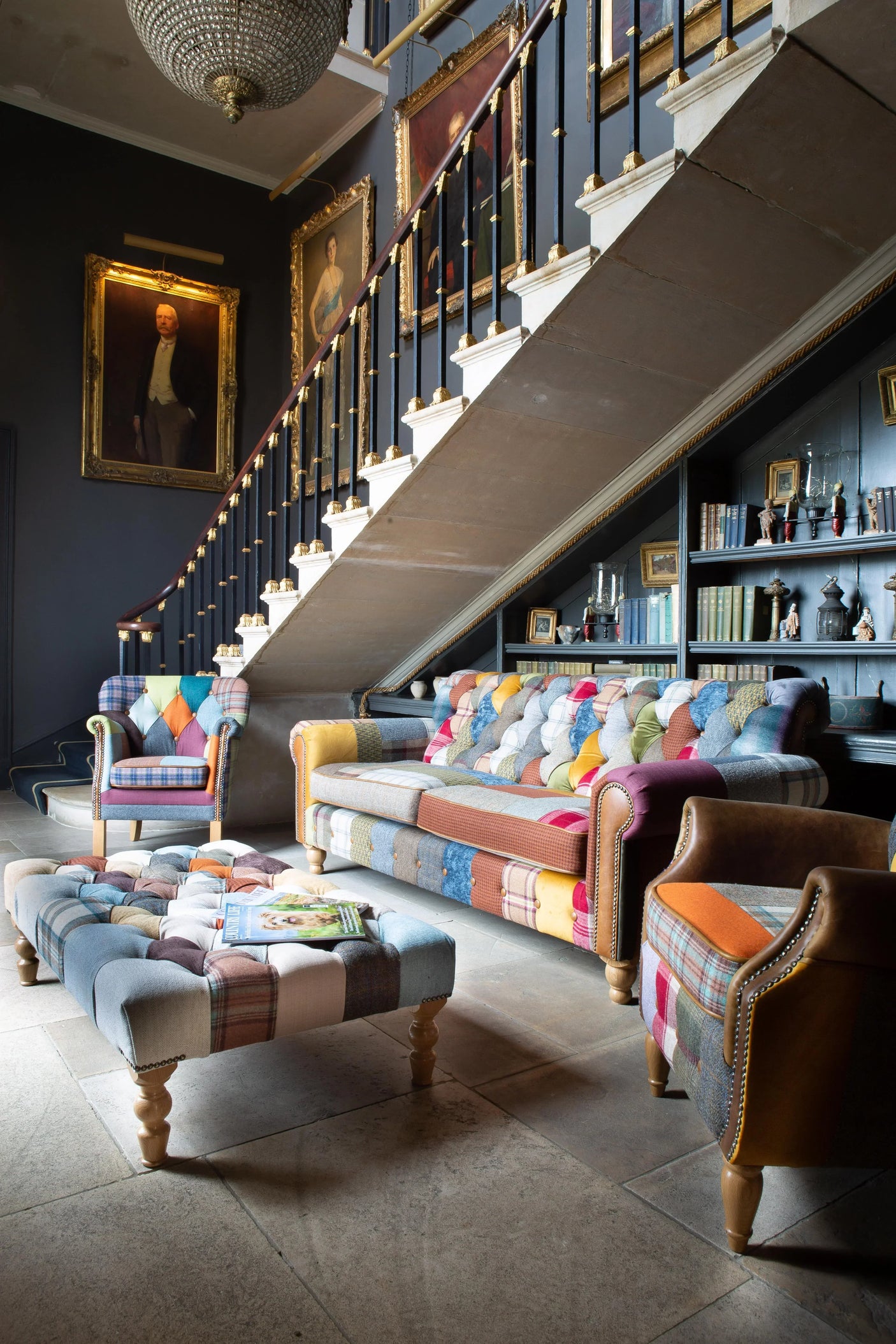 Patchwork fabric sofa set with armchairs and ottoman in a traditional living room setting