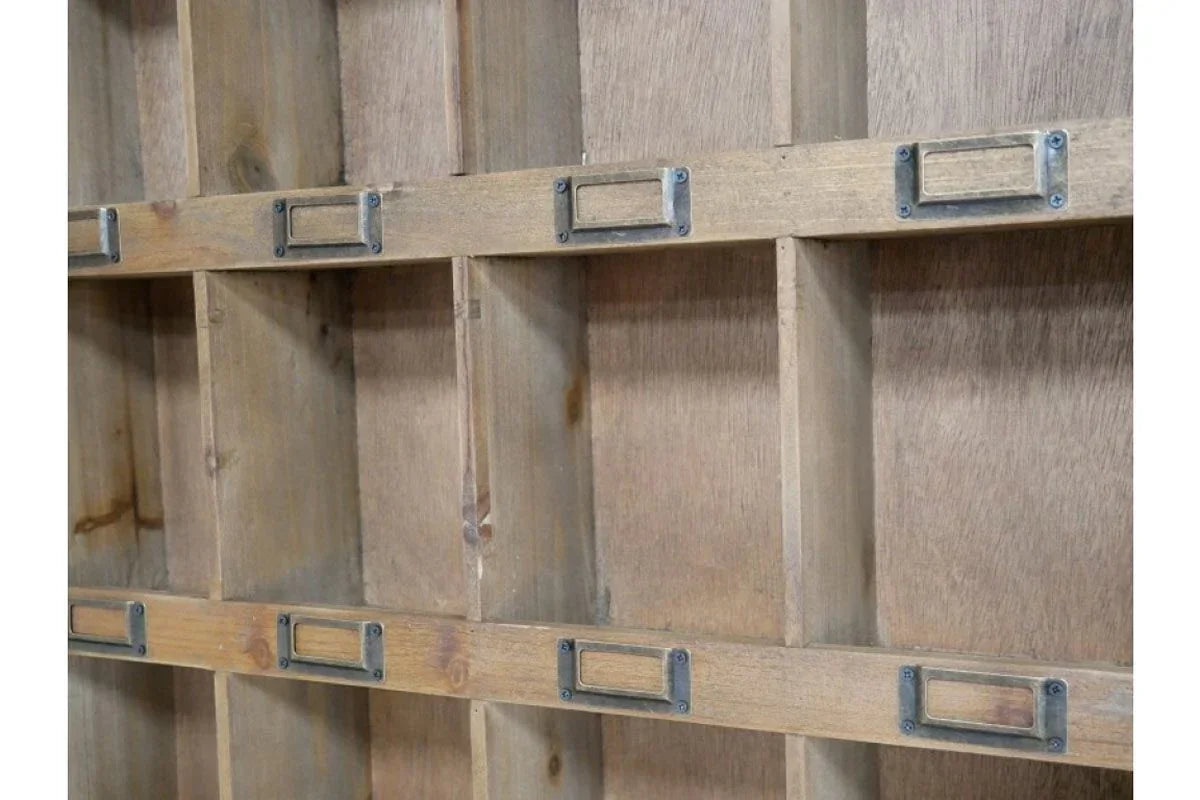 Closeup of wooden shelving unit with compartment dividers and metal label holders