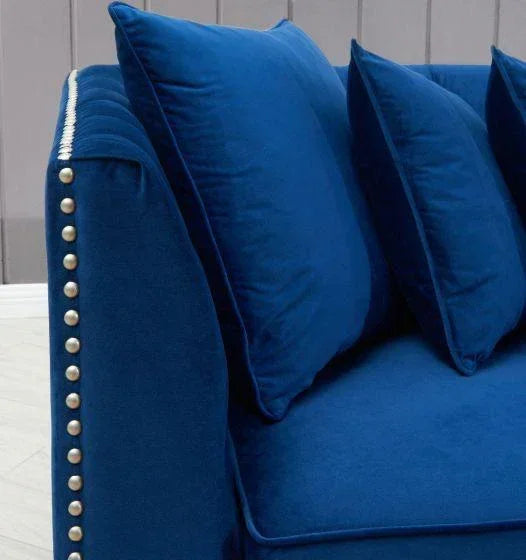 Blue velvet sofa with studded armrest and matching scatter cushions