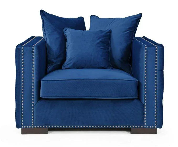 Blue velvet armchair with silver stud trim and three matching scatter cushions, front angle view