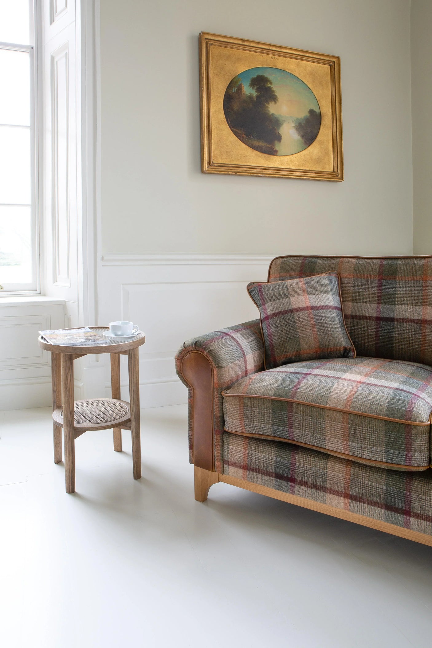 Plaid fabric sofa and cushion with wooden side table in bright living room corner