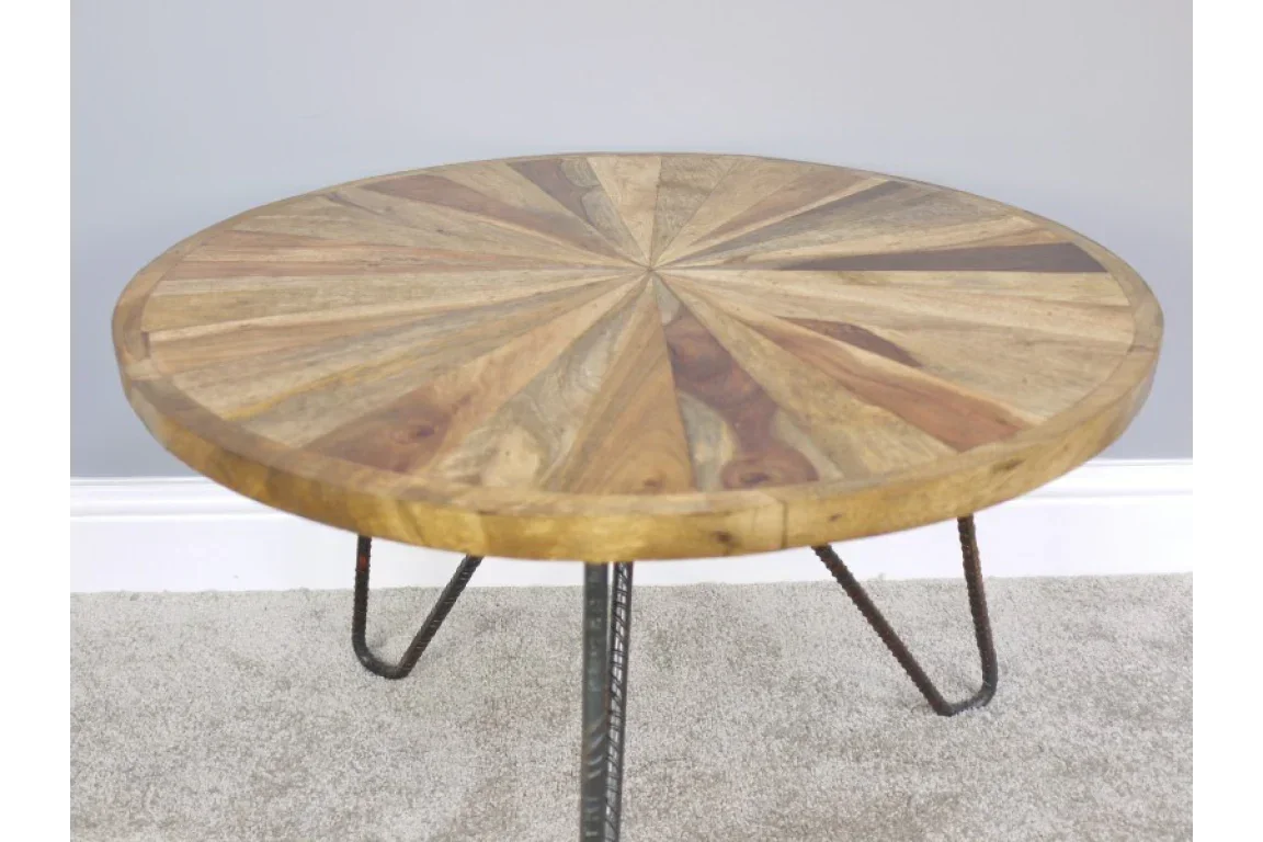 round wooden coffee table with sunburst pattern and metal hairpin legs on carpet