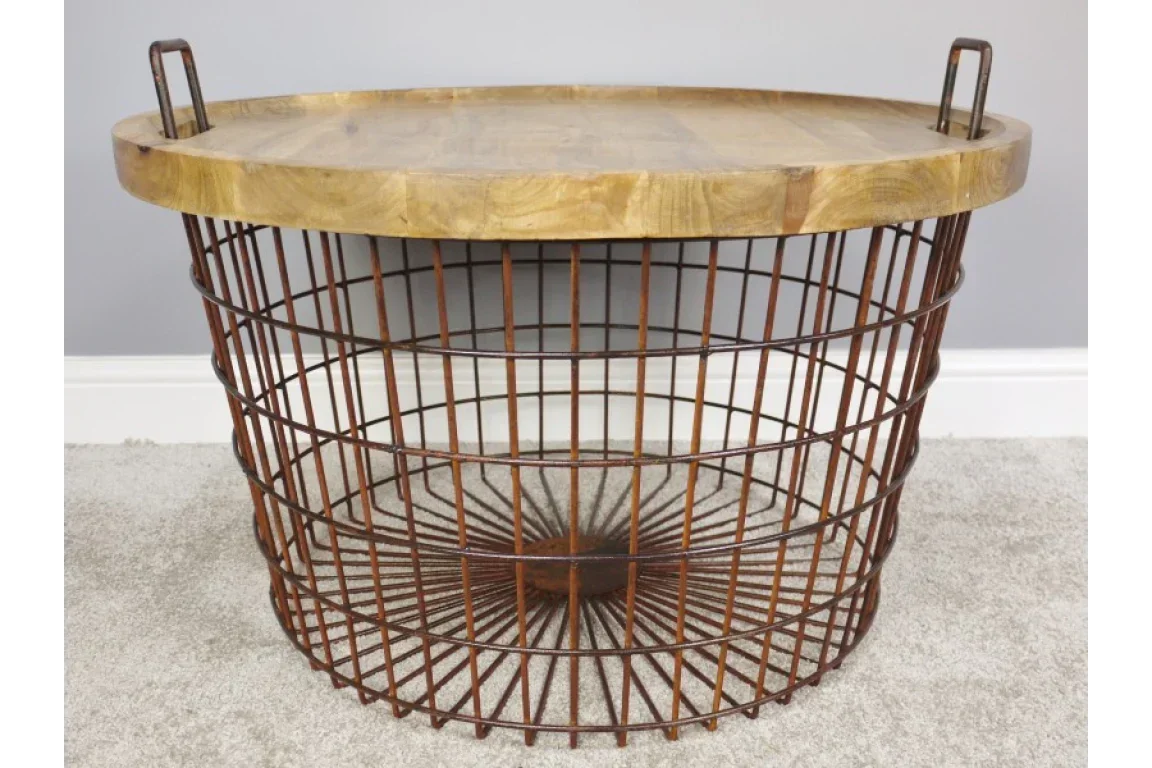 Round wire basket coffee table with wooden top and metal handles on carpet