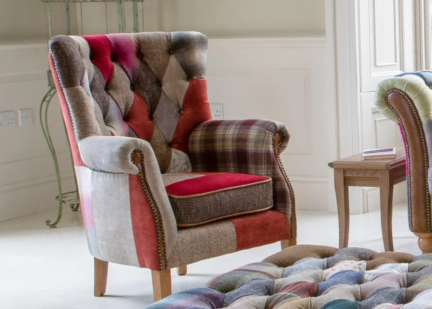 Patchwork armchair with button back and wooden legs in a modern living room setting