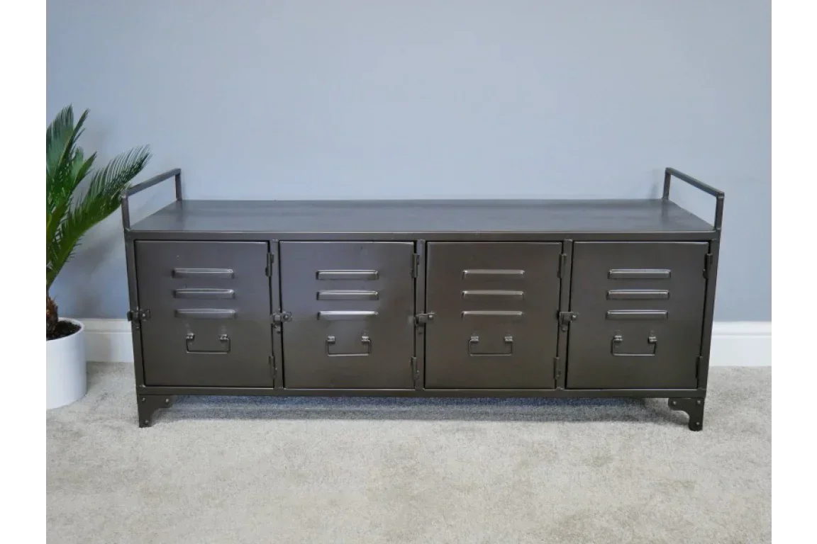 Black metal storage bench with four locker doors and handles on a carpeted floor