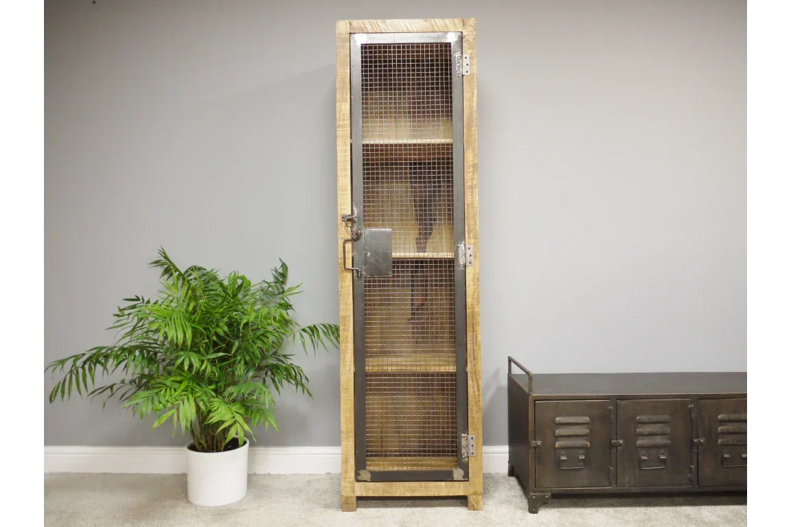 Tall industrial storage cabinet with metal mesh door and wood frame against grey wall