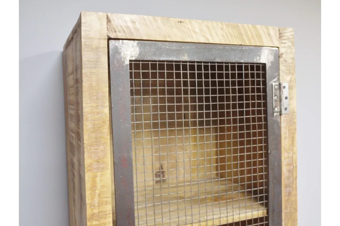 Rustic wooden cabinet with metal mesh door and visible interior shelf