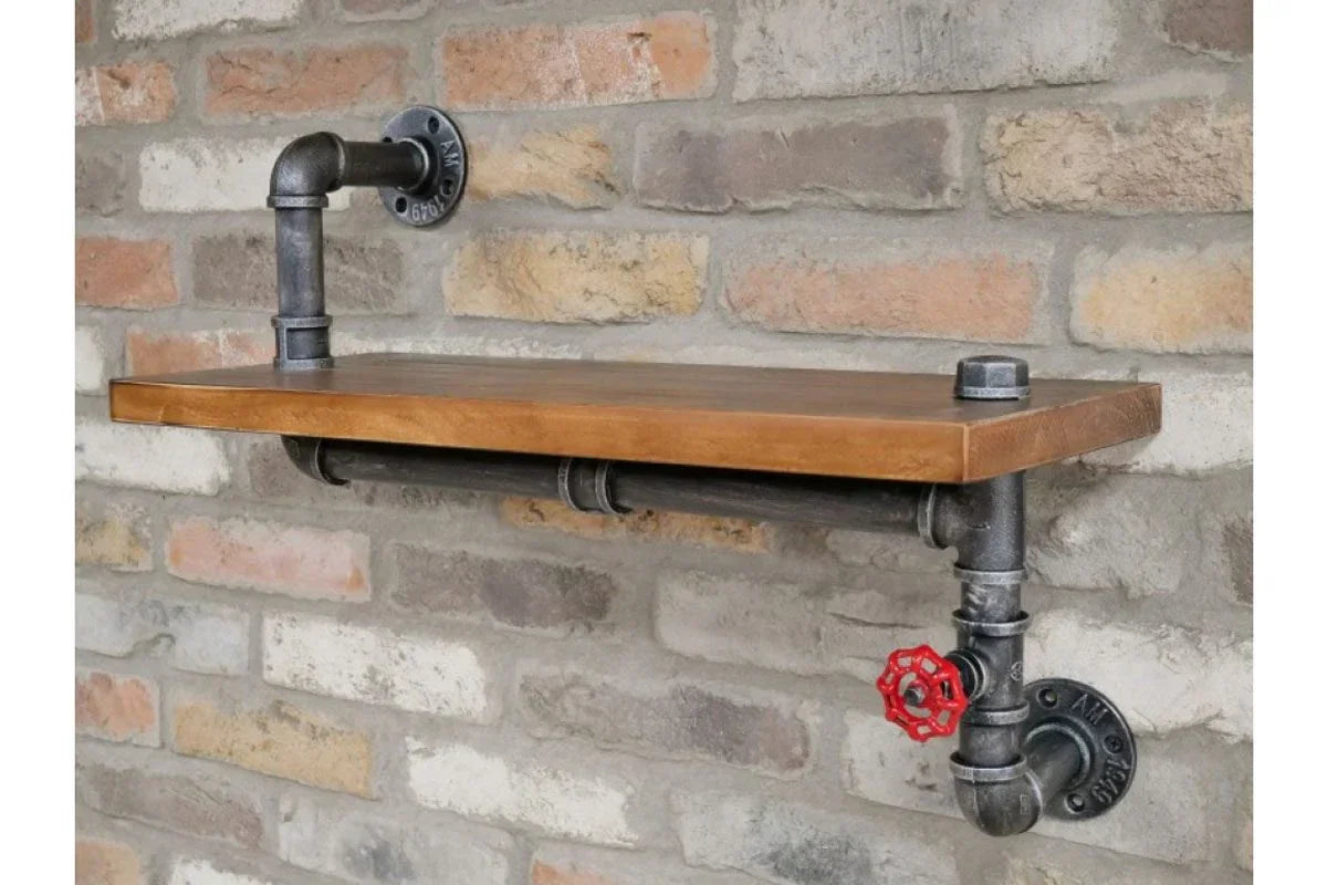 Industrial wall shelf with wood top and black metal pipe brackets on exposed brick wall