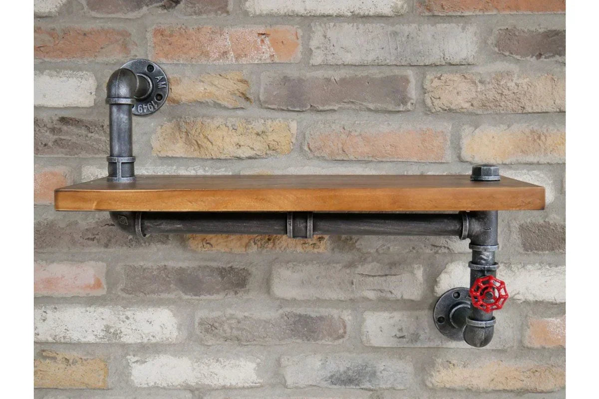 Industrial pipe wall shelf with wooden top and metal fittings on exposed brick wall