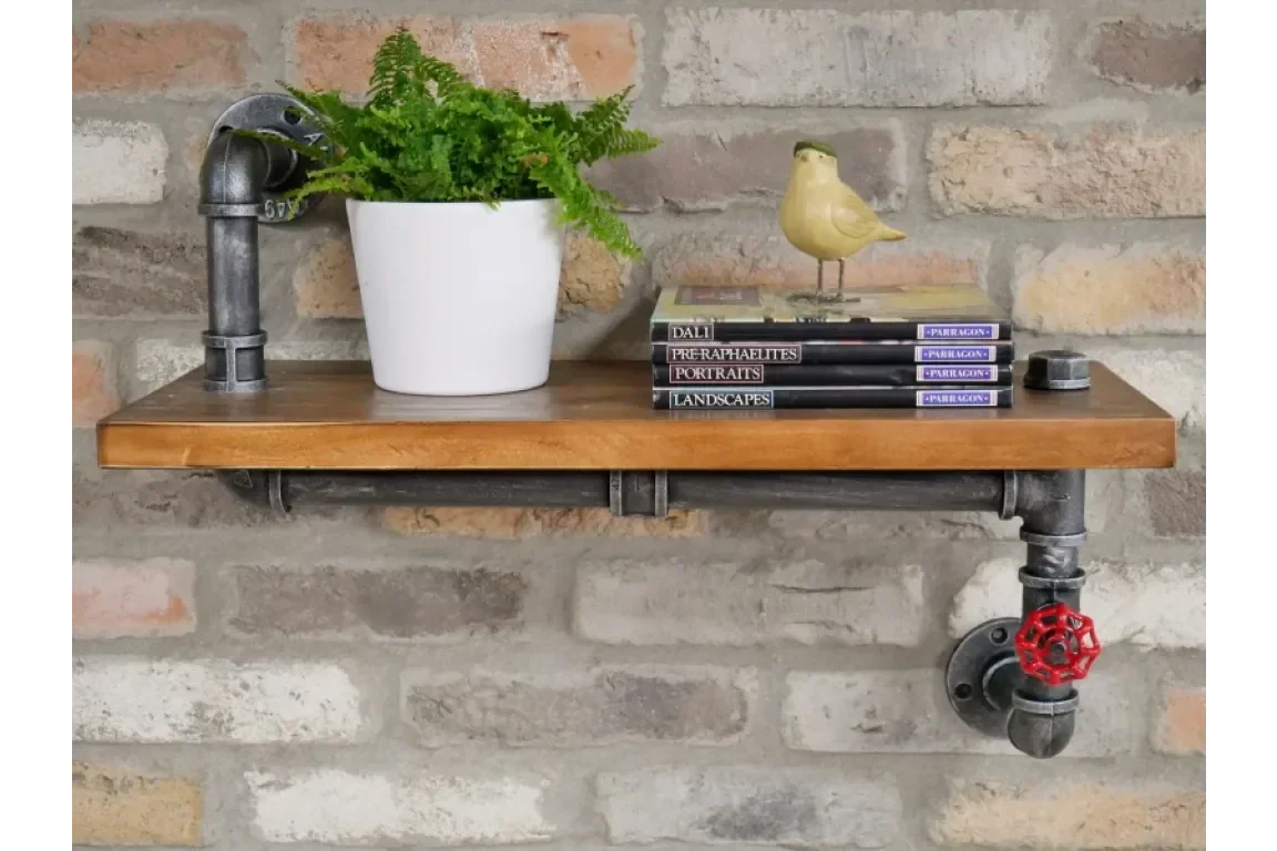 Industrial pipe shelf with wood top, potted fern, decorative books and yellow bird ornament