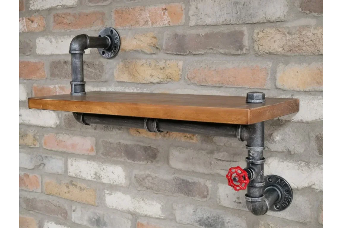 Industrial pipe wall shelf with wood plank and red valve accent mounted on brick wall