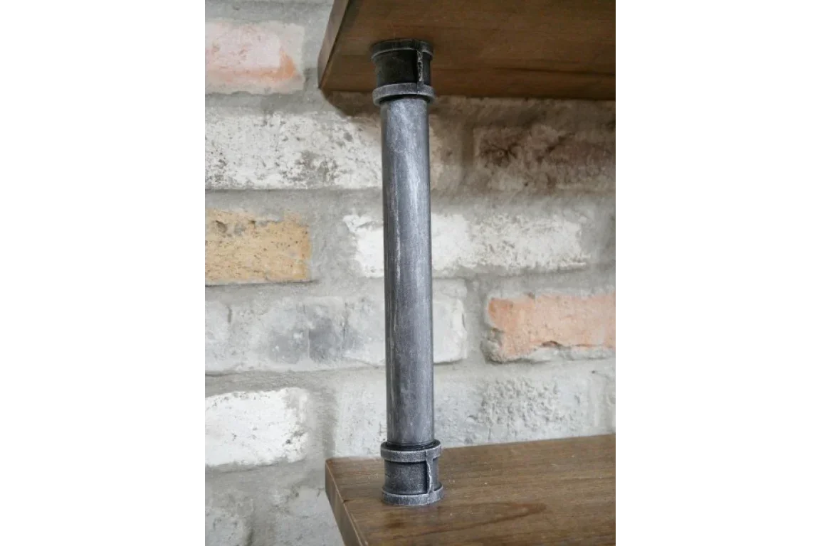 Industrial metal shelf support pipe between two wooden shelves against brick wall