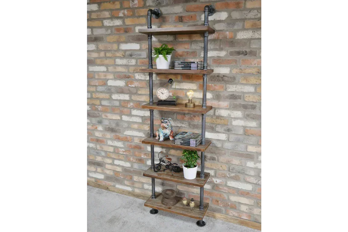 Industrial pipe shelving unit with wooden shelves against exposed brick wall