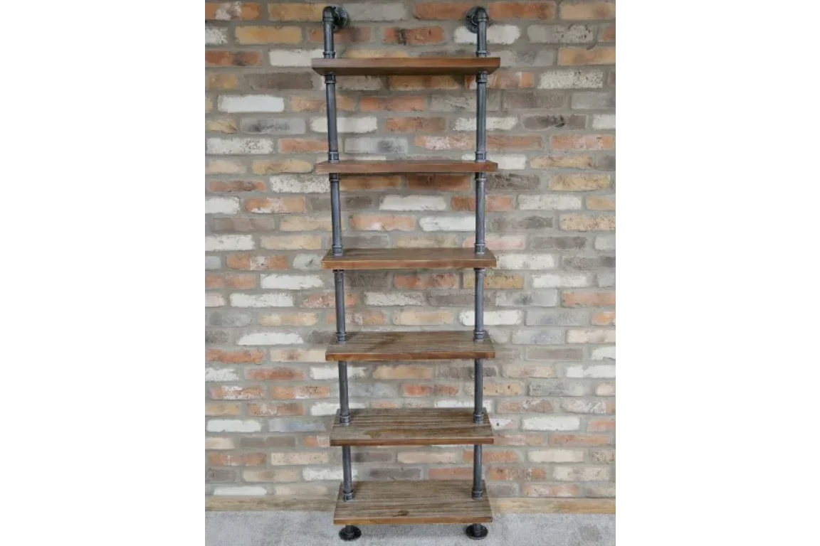 Industrial pipe shelving unit with five wooden shelves against brick wall