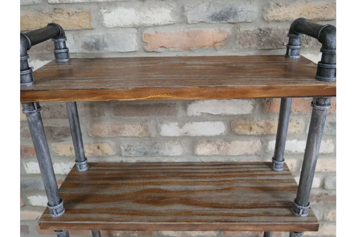 Industrial pipe shelving unit with wooden shelves against exposed brick wall