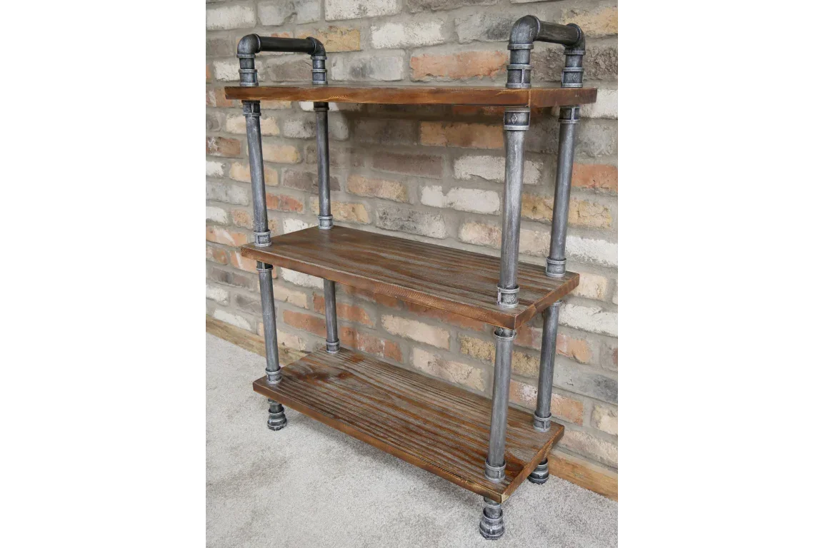Industrial style shelving unit with three wooden shelves and metal pipe frame against brick wall