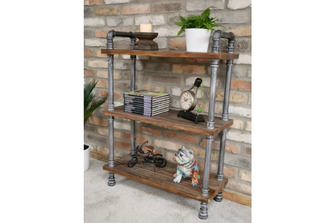 industrial pipe bookshelf with wood shelves against brick wall, decorated with plant, clock, ornaments