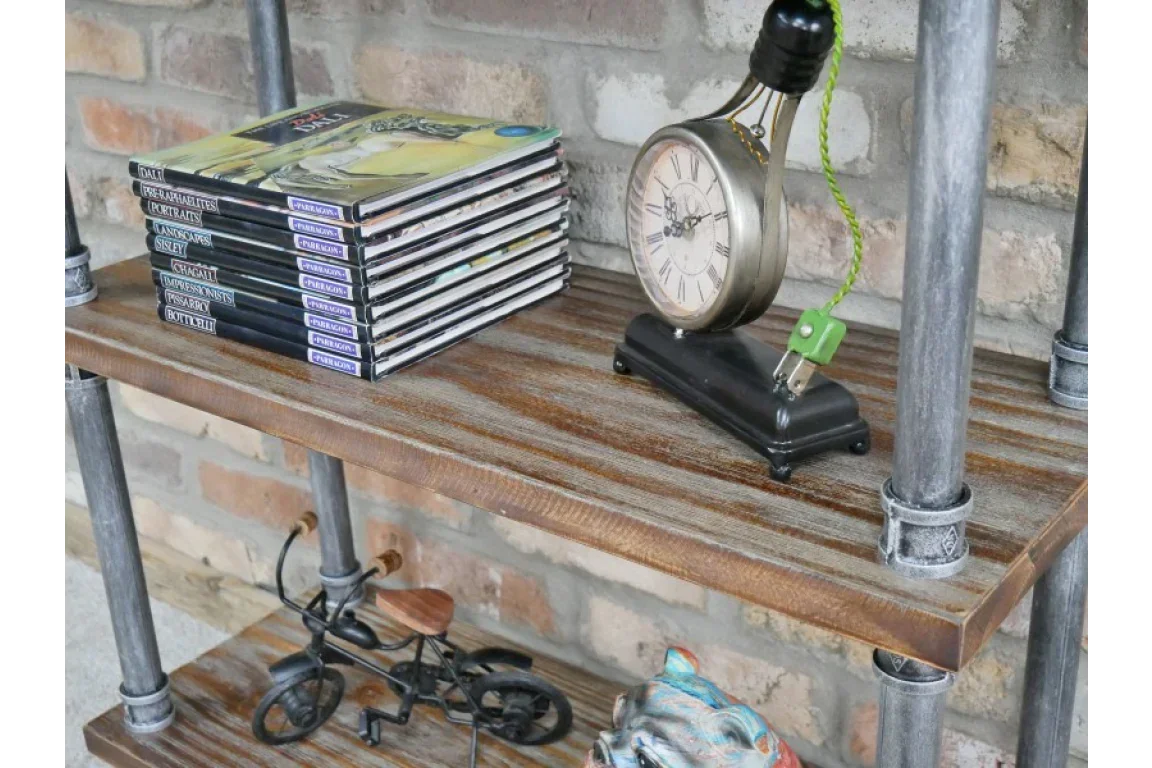 industrial pipe and wood bookshelf with books, table clock, metal bicycle decor