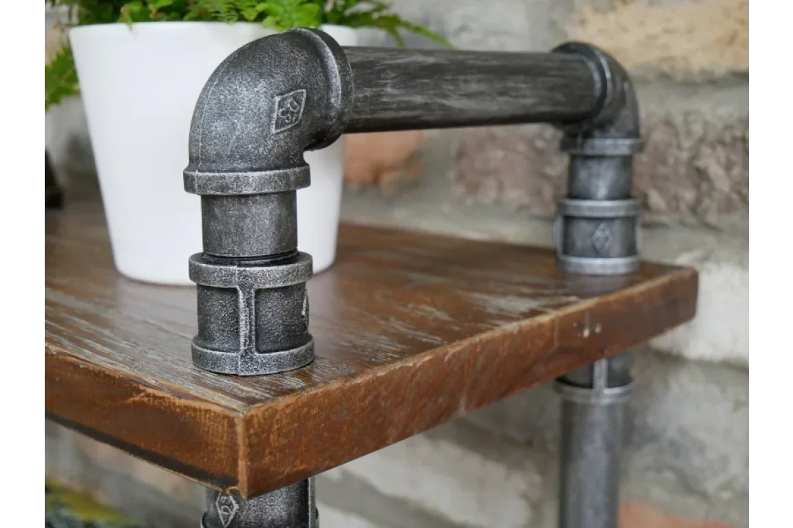 Industrial pipe shelf bracket with rustic wood shelf and white plant pot