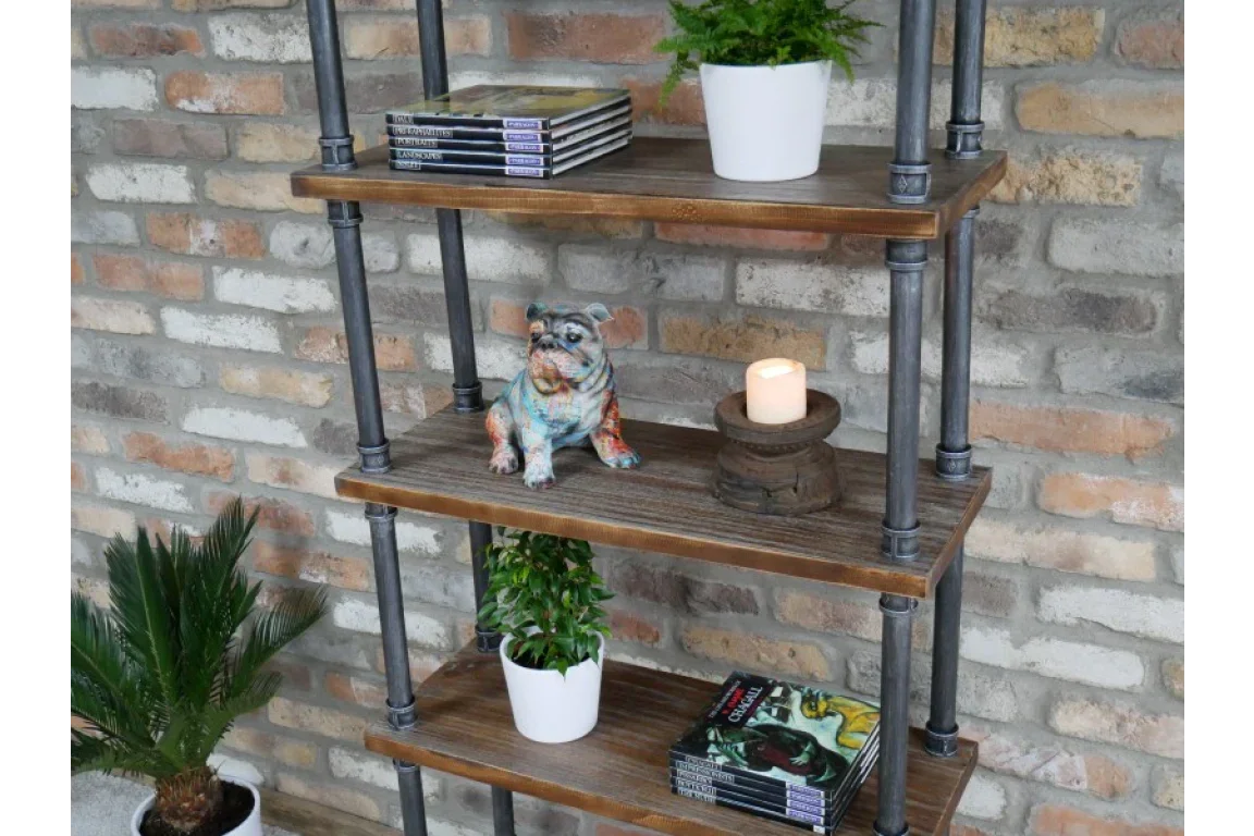 industrial style metal and wood shelving unit with books, potted plants, candle, and dog ornament